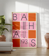 Bauhaus poster with a grid design featuring black letters spelling 'BAUHAUS 193S' on pink squares, interspersed with solid orange squares. - Image 3