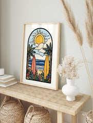 Illustrative beach scene art print with two surfboards, palm trees, ocean, sun, and clouds in, in an alternate framed mockup