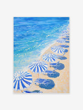 Blue Beach Umbrellas poster showing a painting of a sandy beach with striped umbrellas, lounge chairs, and blue ocean waves.