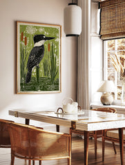 Belted Kingfisher bird perched on a post in a green wetland with cattails and water ripples art, in a styled room mockup