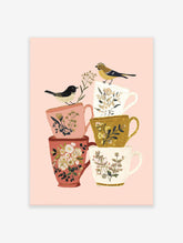 Illustration of two birds on a stack of floral teacups on a pink background