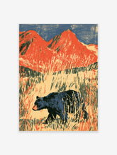Black bear walking through tall meadow grasses with red mountains and blue sky, painterly art print
