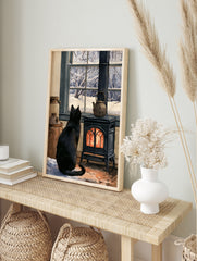 Black cat sitting before a glowing cast-iron stove, looking out a window at a snowy forest, in an alternate framed mockup