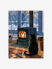 Black cat sitting in front of a glowing cast-iron wood stove with a snowy winter garden outside the window
