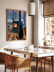 Black cat sitting in front of a glowing cast-iron wood stove with a snowy winter garden outside the, in a styled room mockup