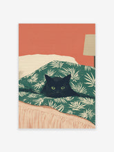 Illustrative print of a black cat with green eyes peeking from a green palm-leaf duvet against a coral wall