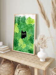 Whimsical black cat poster peeking through vibrant green jungle leaves with bright green eyes and a pink nose illustration. - Image 4