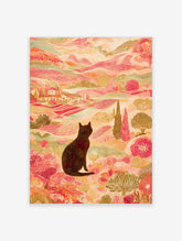 Illustrative print of black cat in colourful landscape with pink hills, green trees, and distant villas