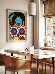 Stylized black cat standing on a decorative Mexican sugar skull with blue, red, and yellow floral, in a styled room mockup
