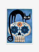 Black cat standing on a decorative blue and orange sugar skull floral illustration on a textured blue background