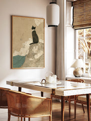 Japanese style black cat print, sitting on swirling mound, gazing over teal waves under beige sky, in a styled room mockup
