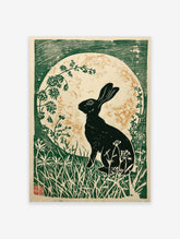 Black hare silhouette against a textured moon, surrounded by green foliage in an illustrative print