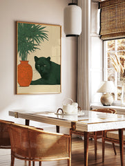 Illustrative black panther lying next to an ornate orange vase and green plant on a beige background, in a styled room mockup
