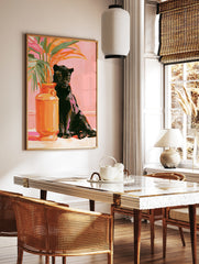 Painterly art print of a black panther sitting next to an orange vase with tropical leaves against, in a styled room mockup
