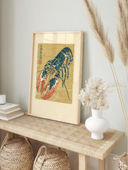 Japanese illustrative blue and red lobster print with kanji script on a tan background, in an alternate framed mockup