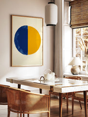Abstract art print of a large circle divided vertically into a textured blue half and a smooth, in a styled room mockup