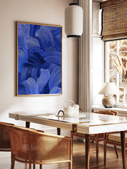 Close-up of blue abstract art with textured, flowing brushstrokes in indigo and cobalt tones, in a styled room mockup