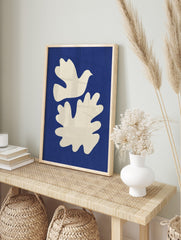 White dove and organic abstract shape on a textured deep blue background, unframed print, in an alternate framed mockup