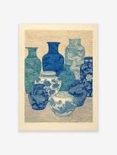 Still life of blue and white vases with intricate Chinoiserie patterns, woodblock print style wall art.