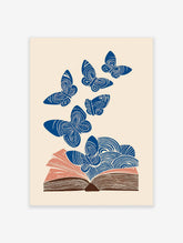Blue butterfly wall art flying from an open book with swirling patterns on a cream background, illustrative style.