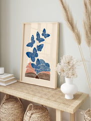 Blue butterfly wall art flying from an open book with swirling patterns on a cream background, illustrative style. - Image 3