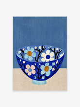 Blue floral bowl art print with light blue and cream flowers on black branches against a blue background