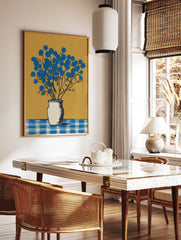 Blue flower wall art featuring a botanical illustration of vibrant blue flowers in a white vase on a checkered table against a gold background. - Image 3