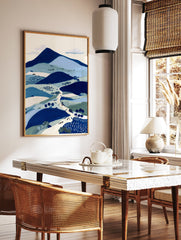 Illustrative blue landscape wall art print featuring mountains, hills, a winding path with figures, and trees. - Image 2