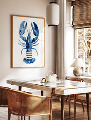Blue lobster watercolour illustration art print on a white background, showing claws and segmented, in a styled room mockup