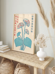 Stylised blue lotus flower botanical print with red accents and Japanese text on an off-white, in an alternate framed mockup