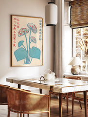 Stylised blue lotus flower botanical print with red accents and Japanese text on an off-white, in a styled room mockup