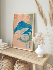 Japanese botanical print of three blue mushrooms with pale gills on green grass, peach, in an alternate framed mockup