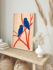 Two blue owls with red eyes perch on bright red branches against a light background, in a modern illustration wall art print. - Image 3