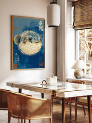 Blue pufferfish art print in Japanese woodblock style, with white spikes and deep blue swirling, in a styled room mockup
