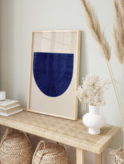 Textured deep blue semi-circle abstract art print with vertical and radiating lines on a, in an alternate framed mockup