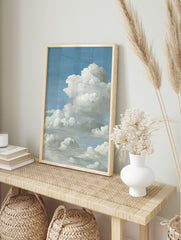 Close-up of fluffy white cumulus clouds against a bright blue sky, filling the vertical frame, in an alternate framed mockup