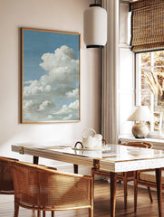Close-up of fluffy white cumulus clouds against a bright blue sky, filling the vertical frame, in a styled room mockup