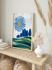 Abstract landscape art print with blue sun, blue trees on green hills, and layered fields, in an alternate framed mockup