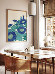 Illustrative blue sunflowers with green leaves and two figures in hats on a cream background, in a styled room mockup