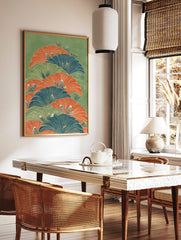 Illustrative botanical wall art with layered fan-like leaves in orange, blue, and green on a green, in a styled room mockup