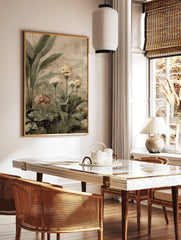 Botanical garden art print with large green leaves, yellow and muted pink flowers, on a distressed, in a styled room mockup