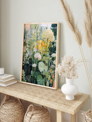 Painterly botanical garden art print with white flowers, green leaves, and yellow accents, in an alternate framed mockup