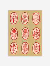 Botanical illustration wall art with nine red line-art flowers in oval frames on a light tan background