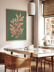 Botanical illustration of a leafy plant with pale pink leaves and red veins on a teal background, in a styled room mockup