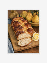 Still life art print of a braided loaf of bread, pears, and a butter curl on a wooden board, warm golden tones