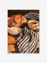 Watercolour painting of a crusty loaf of bread, butter in a bowl, and coffee on a striped fabric background
