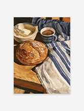 Watercolor illustration of a loaf of bread, bowl of butter, and coffee cup on a blue striped cloth table