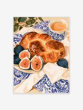 Watercolor illustration of a braided loaf of bread, fresh figs, and a cup of tea on a blue patterned cloth