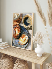 Close-up illustration of two coffee mugs and a buttered bread roll on a blue plate, breakfast, in an alternate framed mockup