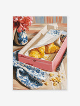 Breakfast Croissant Poster featuring two golden croissants in a pink box, a blue floral napkin, and red flowers in a vase.